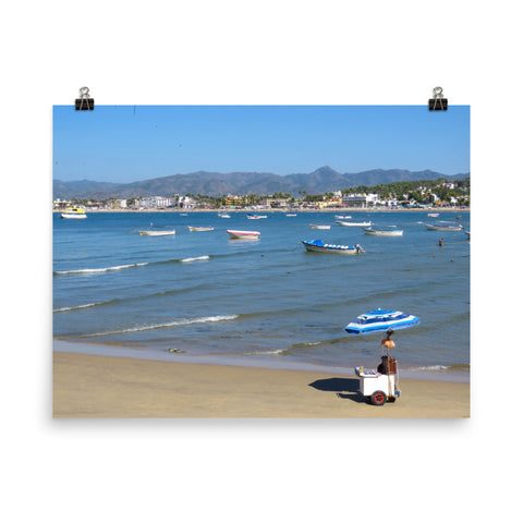 Beach with vibrant blues, boats, and mountains behind - Print