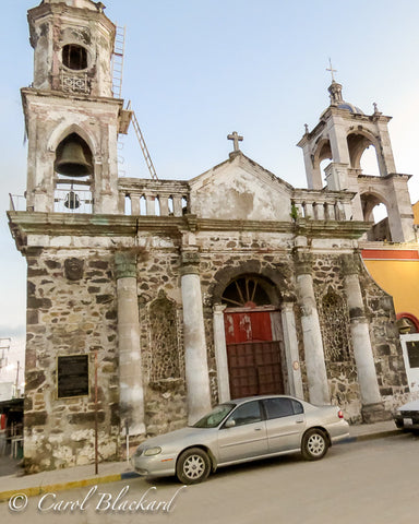 Old mission under renovation with bell tower