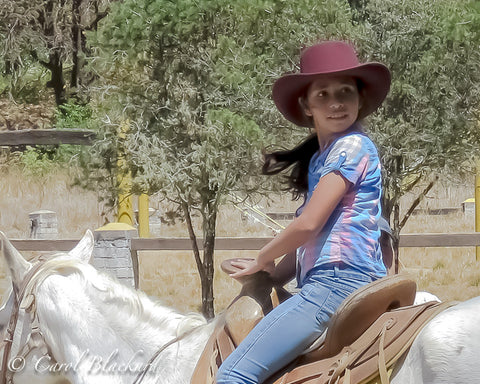 Adorable Little Mexican girl on white horse